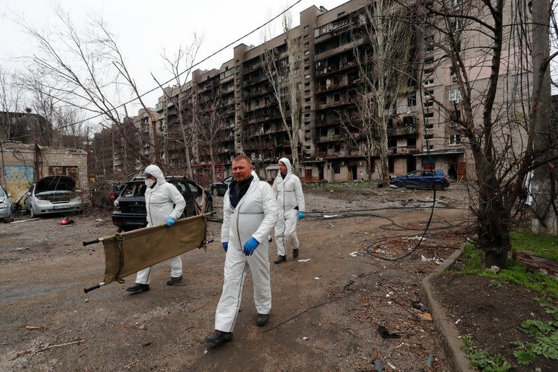 Emergency management specialists search for the bodies of killed people in Mariupol