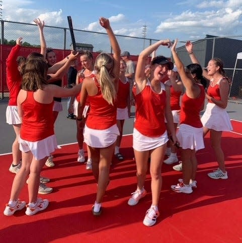 Bedford's tennis players celebrate the Division 2 Regional championship they won Thursday.