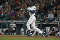 Seattle Mariners' Kyle Lewis watches his a solo home run against the Houston Astros during the second inning of a baseball game, Saturday, May 28, 2022, in Seattle. (AP Photo/Ted S. Warren)