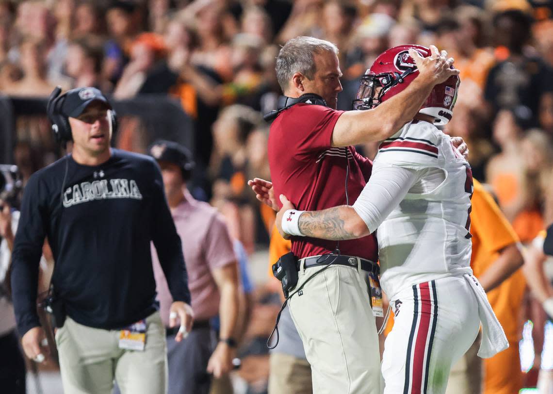 South Carolina quarterback Spencer Rattler (7) is congratulated by head coach Shane Beamer after scoring a touchdown during the first half of the Gamecocks’ game at Neyland Stadium in Knoxville on Saturday, September 30, 2023.