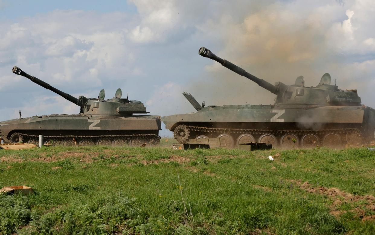 Self-propelled artillery vehicles firing towards Ukrainian army positions near the town of Yasynuvataya, outside Donetsk - Alexei Alexandrov/AP