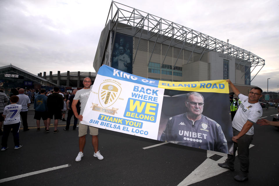 Leeds United fans celebrate outside Elland Road after Huddersfield Town beat West Bromwich Albion to seal their promotion to the Premier League.