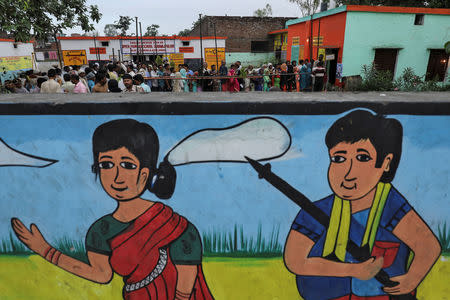 Voters line up to cast their votes outside a polling station during the second phase of general election in Amroha, in the northern Indian state of Uttar Pradesh, India, April 18, 2019. REUTERS/Anushree Fadnavis