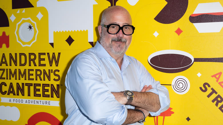 Andrew Zimmern with colorful backdrop