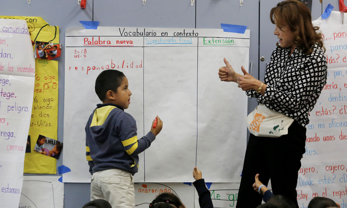 Sandra Saenz-Urias (right), a kindergarten teacher at Parkview School, gives a thumbs up as she teaches Diego Lopez-Ramirez (left) a lesson on December 10, 2014 in El Monte.