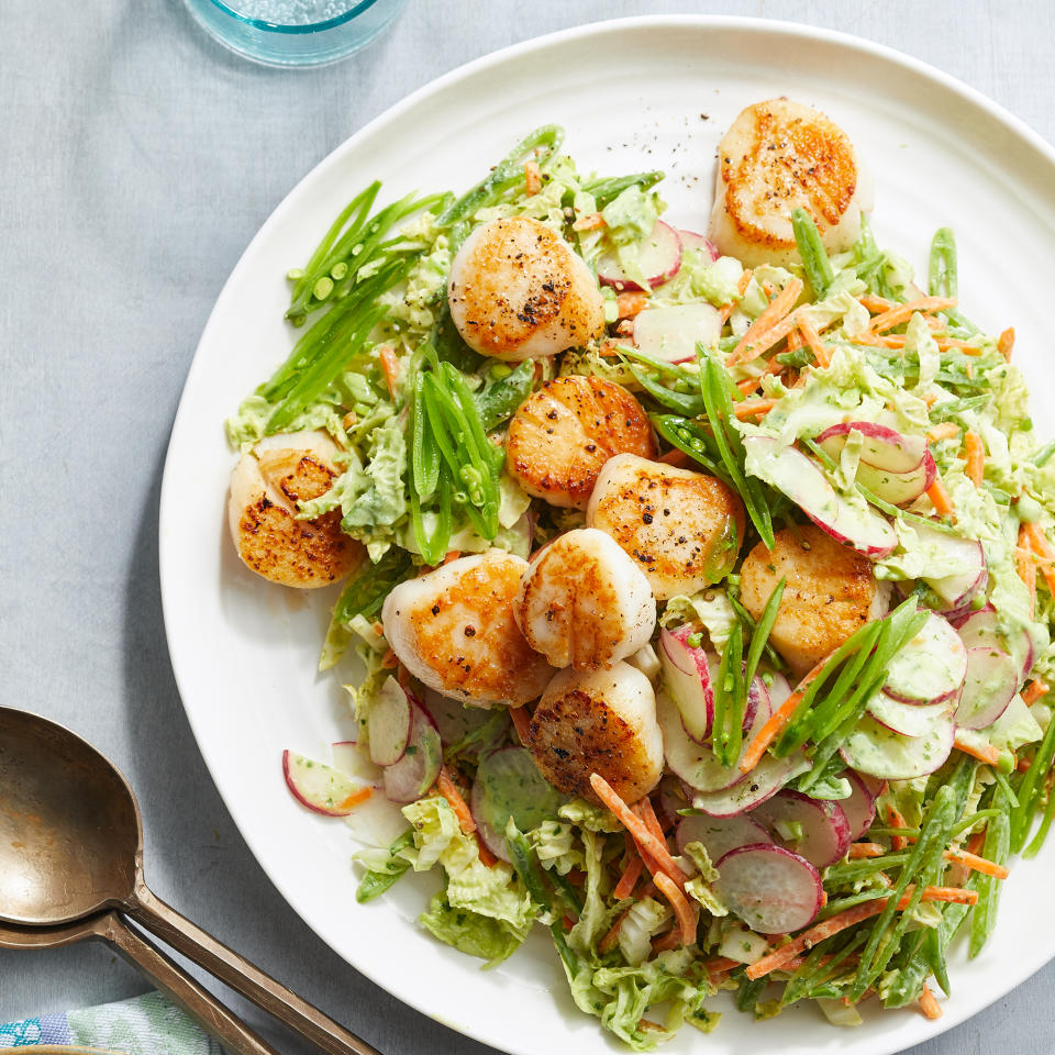 <p>Avocado, yogurt and buttermilk lend creaminess to the herbaceous dressing coating this salad. <a href="https://www.eatingwell.com/recipe/7951431/seared-scallops-with-green-goddess-slaw/" rel="nofollow noopener" target="_blank" data-ylk="slk:View Recipe;elm:context_link;itc:0;sec:content-canvas" class="link ">View Recipe</a></p>