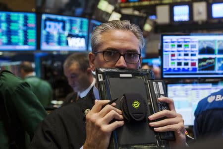 A trader works on the floor of the New York Stock Exchange shortly after the opening bell in New York August 26, 2015. REUTERS/Lucas Jackson