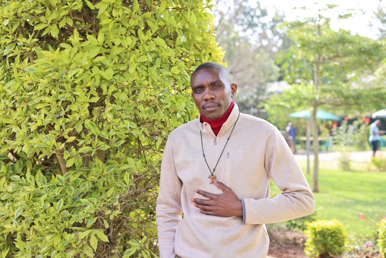 Michael Mong'are Ooga, training to become a priest, stands in the garden of the Franciscan Missionaries of Hope seminary in Nairobi, Kenya. “Once I’ve committed myself, I cannot refuse,” he said.
