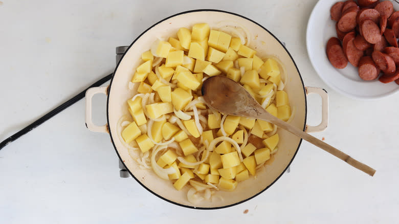 browned onions, garlic, and potato in a pan