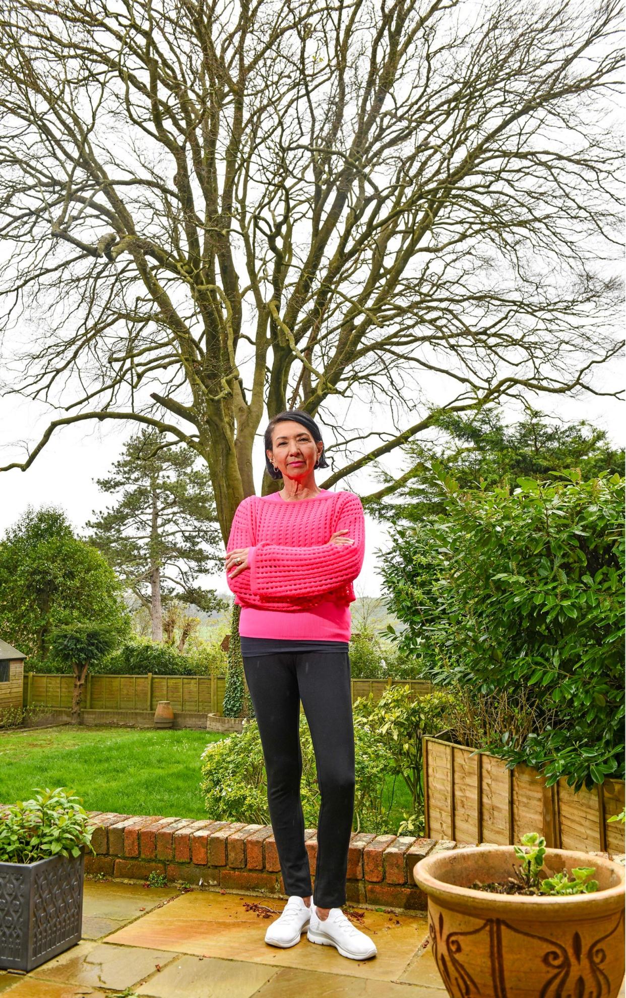 Mrs Faulkner standing in her garden