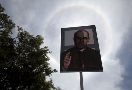 A picture of late Archbishop of San Salvador Oscar Arnulfo Romero is seen under solar halo during his beatification ceremony at El Salvador del Mundo square in San Salvador, May 23, 2015. REUTERS/Jose Cabezas