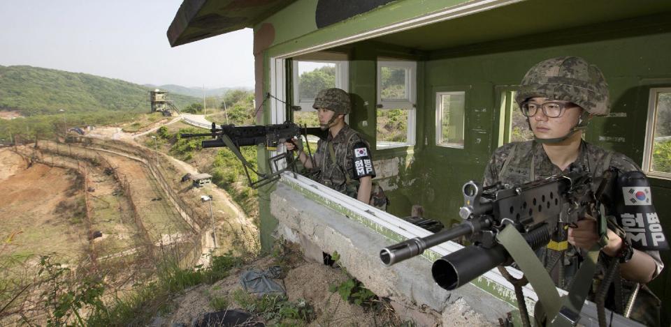 South Korean army soldiers guard at a check point at the demilitarized zone (DMZ) in Cheorwon, South Korea, Tuesday, May 13, 2014. North Korea warned Tuesday that a South Korean official would pay the dear price for saying the North “must disappear soon” in an escalation of war of words between the rivals. (AP Photo/Yonhap, Lim Byung-shik) KOREA OUT