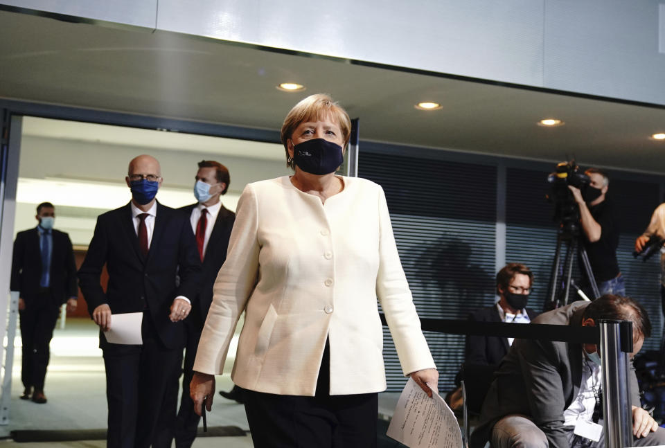 German Chancellor Angela Merkel, foreground arrives for a coronavirus press conference, in Berlin, Tuesday, Sept. 29, 2020. Chancellor Angela Merkel and the governors of Germany’s 16 states conferred on how to prevent the country’s coronavirus infection figures from accelerating to the levels being seen in other European countries. (Kay Nietfeld/dpa via AP)