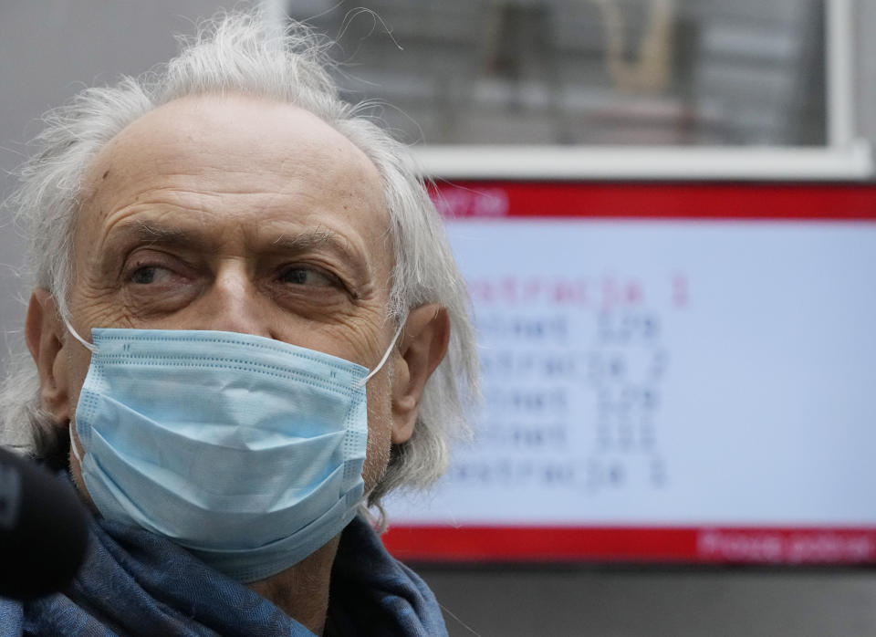 A man waits in a vaccine center after getting a shot against COVID-19 in in Warsaw, Poland, Tuesday Dec. 7, 2021. Poland and several other countries across central and eastern Europe are battling a massive surge of infection and death fueled by the transmissible delta variant. Now they face the specter of the another variant, omicron, with vaccinations rates far lower in the Western Europe. (AP Photo/Czarek Sokolowski)