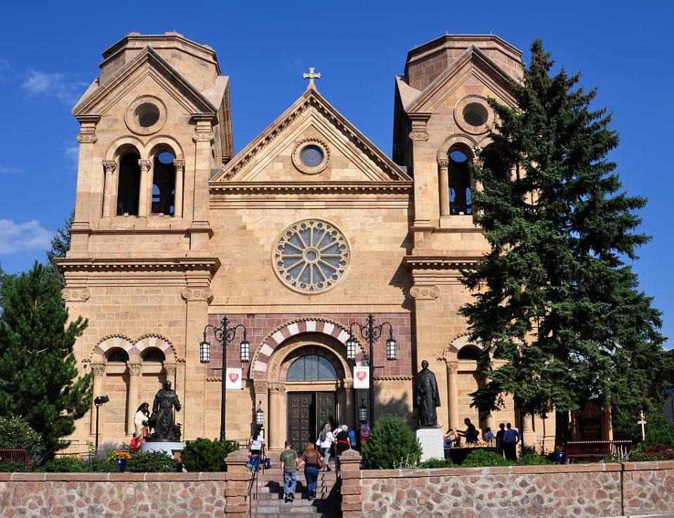 ��Visitors enter the Cathedral Basilica of St. Francis of Assisi in Santa Fe, New Mexico. The Roman Catholic church was built between 1869 and 1886.