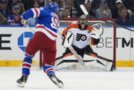 Philadelphia Flyers goaltender Samuel Ersson (33) makes a save against New York Rangers center Mika Zibanejad (93) during the first period of an NHL hockey game Thursday, April 11, 2024, at Madison Square Garden in New York. (AP Photo/Mary Altaffer)