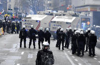 Riot police officers deployed to block the street during a protest against coronavirus measures in Brussels, Belgium, Sunday, Dec. 5, 2021. Hundreds of people marched through central Brussels on Sunday to protest tightened COVID-19 restrictions imposed by the Belgian government to counter the latest spike in coronavirus cases. (AP Photo/Geert Vanden Wijngaert)