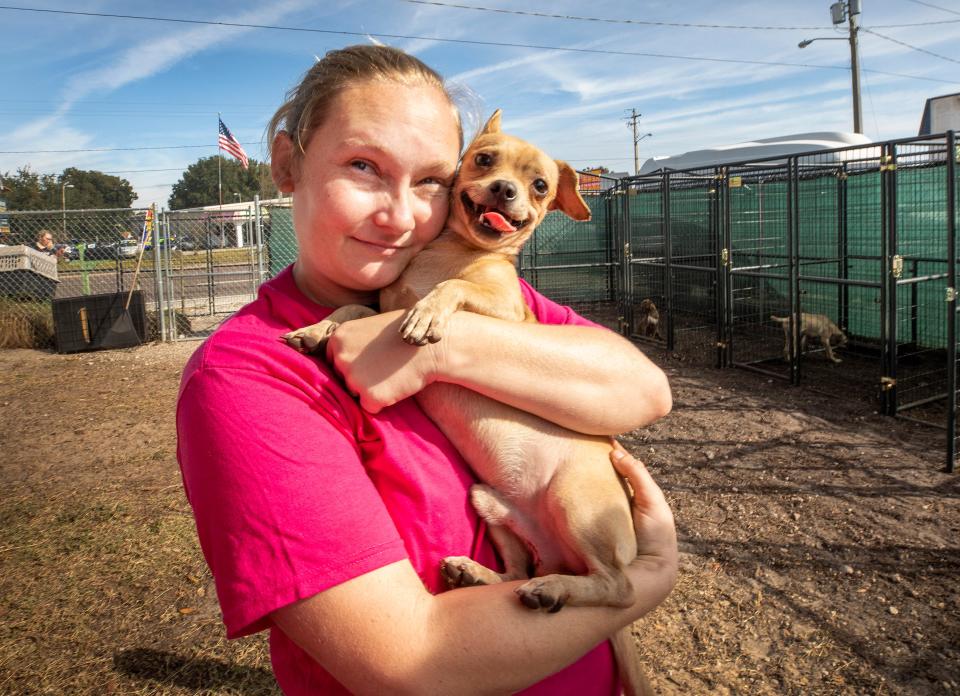 Laci Brooks with one of their rescue dogs at the Crossed Paws Pet Rescue shelter in Winter Haven.
ERNST PETERS/ THE LEDGER