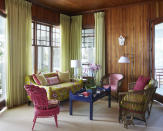 <p> To liven up this wood-clad living room, interior designer Anne Hepfer created a playful focal point with an assortment of living room seating and furniture in contrasting colors, bold prints and sculptural shapes.  </p> <p> 'My clients spent years painstakingly restoring the nineteenth-century home, and my mandate, once I arrived on the scene, was to fill the rooms with vibrant hues,' says Anne Hepfer. 'The timing was perfect: I’d just come back from three weeks in India, so the colors and hand-blocked fabrics I learned about there were my guiding principle. These people are fun, eclectic, and even a little outrageous; they move up here for the summer and their cottage hums with kids, cats, and dogs. Their favorite colors are green and raspberry, so that became the jumping-off point for the preppy-boho getaway of their dreams.' </p>