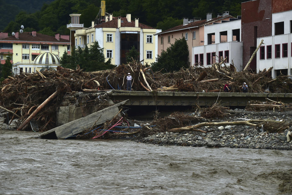 A man watches the destruction after floods and mudslides killed about three dozens of people, in Bozkurt town of Kastamonu province, Turkey, Friday, Aug. 13, 2021. The death toll from devastating floods and mudslides in northern Turkey rose to at least 31 on Friday, officials said, as emergency services searched for survivors in collapsed buildings or swamped homes, shops and basements. An opposition politician said more than 300 people may be unaccounted-for.(AP Photo)