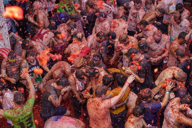 Revellers throw tomatoes at each 