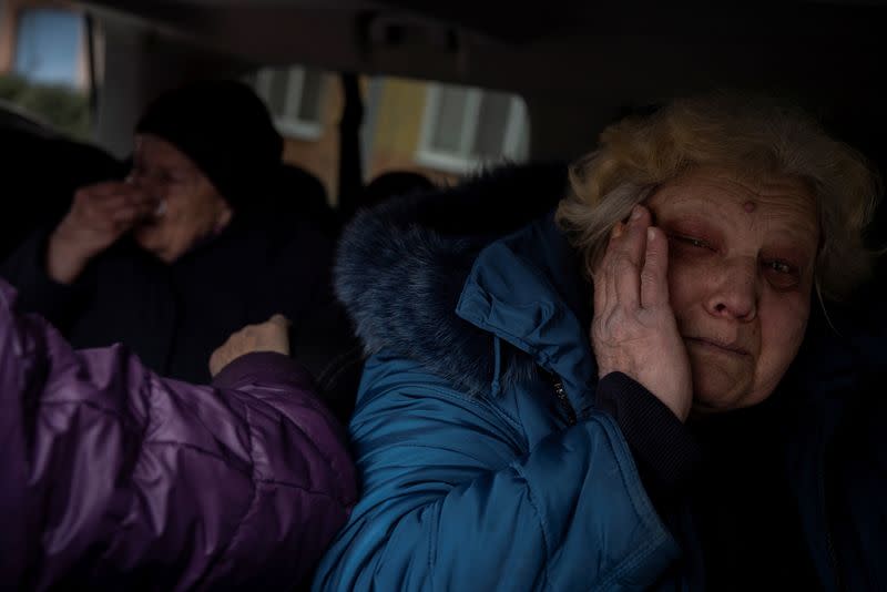 Marina Batrak reacts as she is evacuated from her home in Selydove