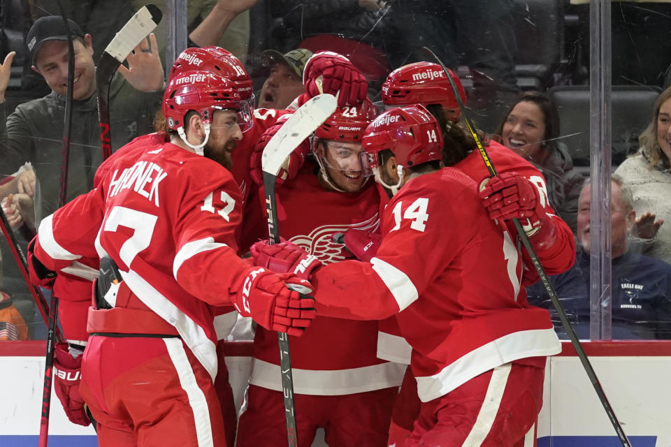 Detroit Red Wings center Pius Suter (24) celebrates his goal against the Dallas Stars in the second period of an NHL hockey game Friday, Jan. 21, 2022, in Detroit. (AP Photo/Paul Sancya)