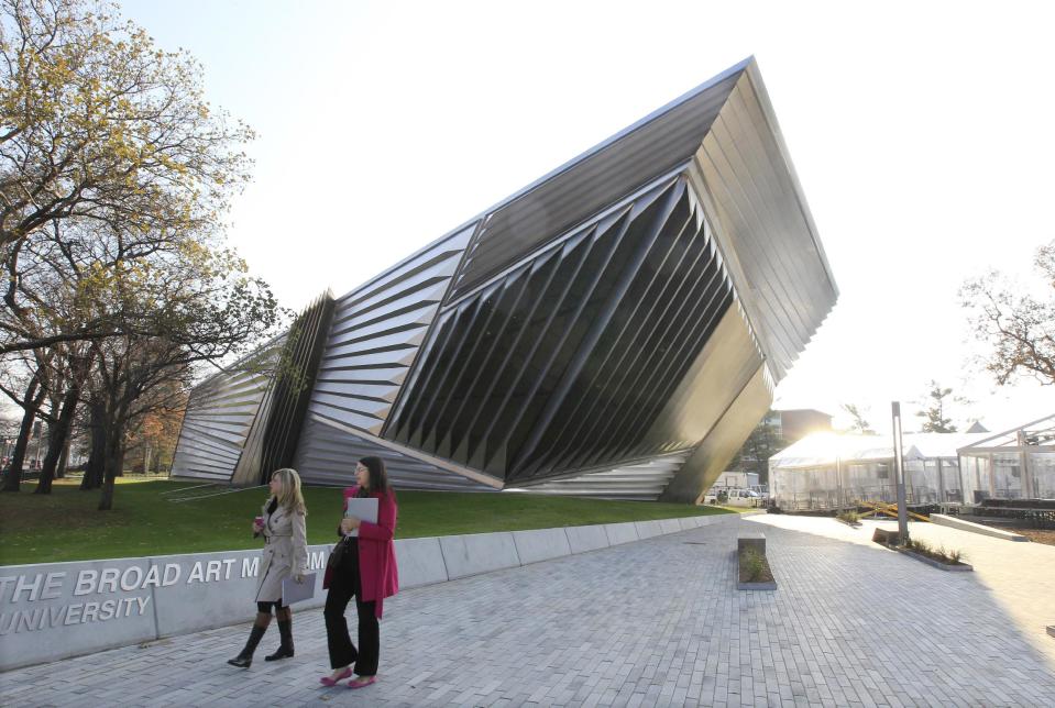 In this Nov. 9, 2012 photo the exterior of the Eli and Edythe Broad Art Museum is seen on the campus of Michigan State University in East Lansing, Mich. The museum features Zaha Hadid's signature look: a facade of pleated stainless steel and glass, which distinguishes it from the traditional brick Collegiate Gothic buildings that surround it on Michigan State's north campus. (AP Photo/Carlos Osorio)