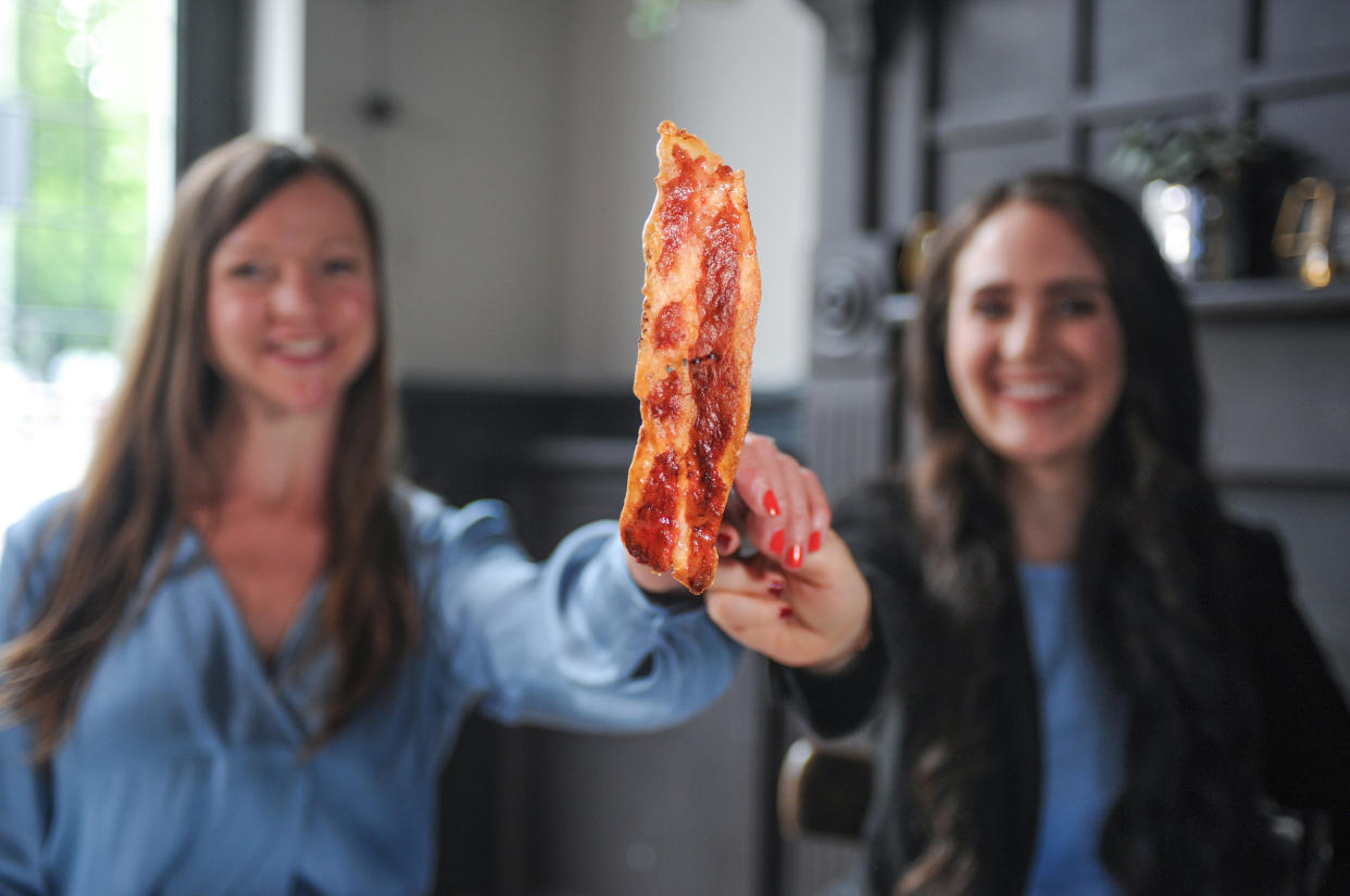 Higher Steaks head of R&D Ruth Faram (l) and CEO Benjamina Bollag (r) with their lab-grown bacon prototype