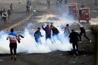 Iraqi demonstrators gesture during ongoing anti-government protests in Baghdad