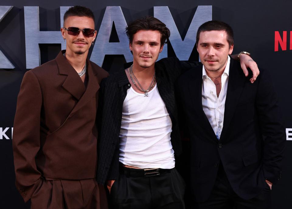 Romeo Beckham (L), Cruz Beckham (C) and thier borther Brooklyn Beckham pose at the "Beckham' premiere on October 3, 2023.