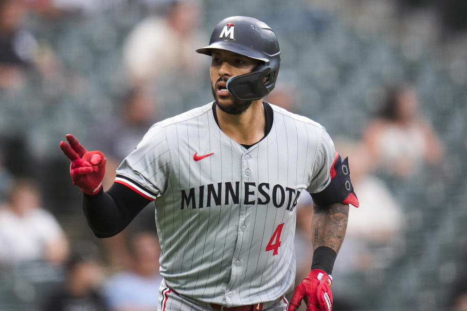 Minnesota Twins' Carlos Correa signals to the dugout after hitting a home run during the sixth inning of the second baseball game of a doubleheader against the Chicago White Sox, Wednesday, July 10, 2024, in Chicago. (AP Photo/Erin Hooley)