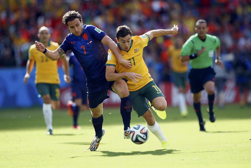 Daryl Janmaat of the Netherlands (L) fights for the ball with Australia's Tommy Oar during their 2014 World Cup Group B soccer match at the Beira Rio stadium in Porto Alegre June 18, 2014. REUTERS/Darren Staples (BRAZIL - Tags: SOCCER SPORT WORLD CUP)