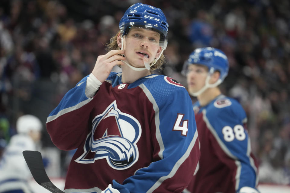 Colorado Avalanche defenseman Bowen Byram adjusts his helmet in the second period of an NHL hockey game against the Tampa Bay Lightning, Tuesday, Feb. 14, 2023, in Denver. (AP Photo/David Zalubowski)