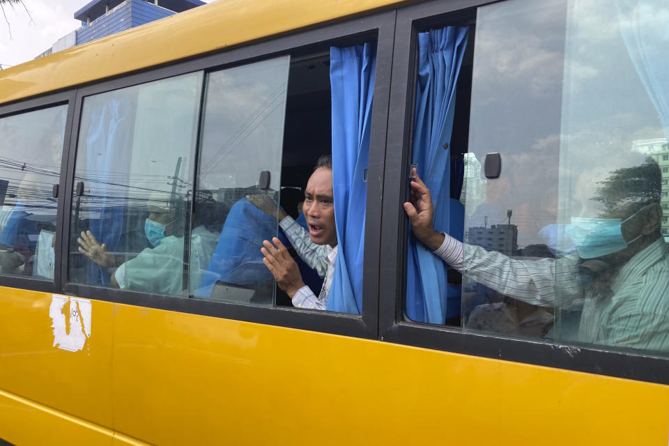 A released prisoner shouts from a bus while they leave from Insein Prison in Yangon, Myanmar Wednesday, May 3, 2023. Myanmar’s ruling military council says it is releasing more than 2,100 political prisoners as a humanitarian gesture. Thousands more remain imprisoned on charges generally involving nonviolent protests or criticism of military rule, which began when the army seized power in 2021. (AP Photo/Thein Zaw)