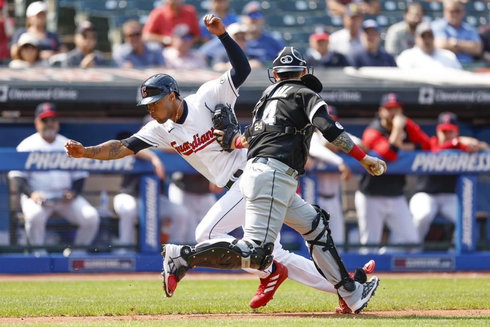 Cleveland Guardians' Will Benson is tagged out in a rundown by Chicago White Sox catcher Yasmani Grandal on a fielders choice by Steven Kwan during the second inning of a baseball game, Thursday, Sept. 15, 2022, in Cleveland. (AP Photo/Ron Schwane)