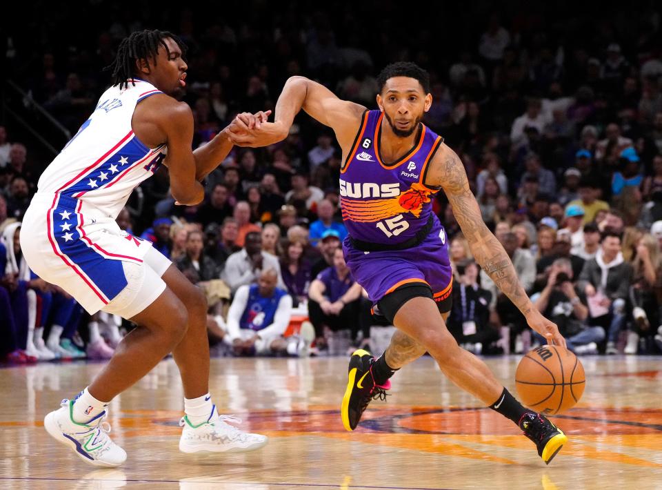 Suns guard Cameron Payne (15) drives by 76ers guard Tyrese Maxey (0) during a game at Footprint Center in Phoenix on March 25, 2023.