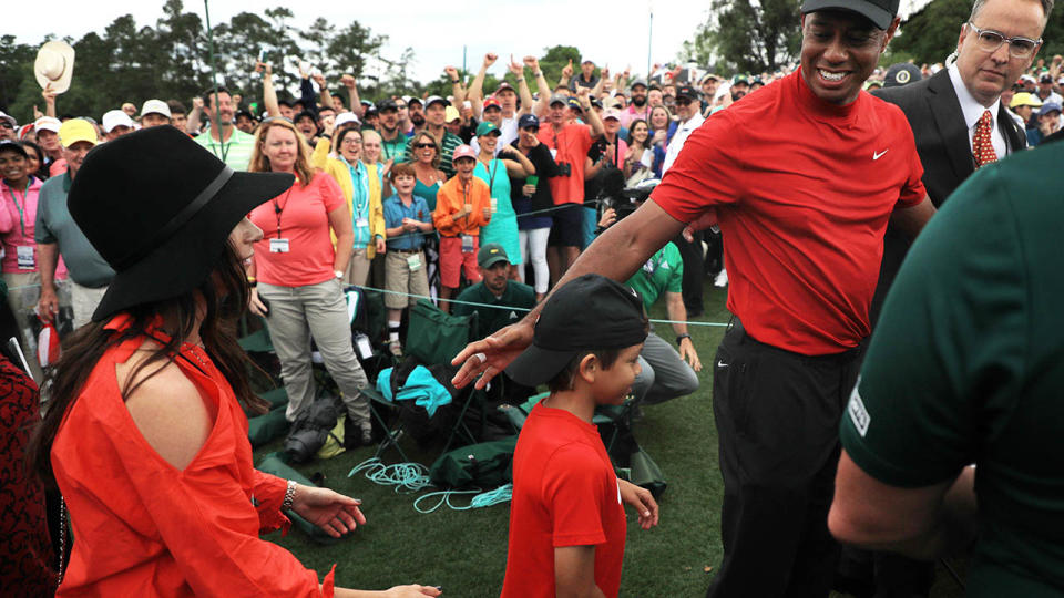 Tiger Woods celebrates with girlfriend Erica Herman and son Charlie Axel. (Photo by Mike Ehrmann/Getty Images)