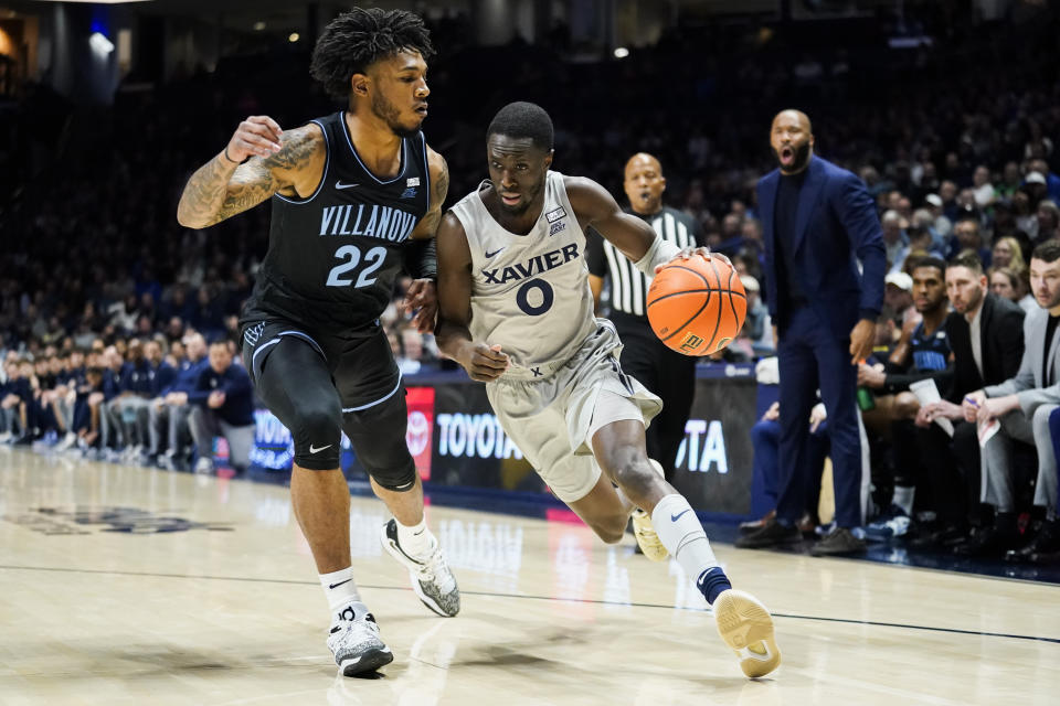 Xavier guard Souley Boum (0) drives to the basket as Villanova forward Cam Whitmore (22) defends during the first half of an NCAA college basketball game, Tuesday, Feb. 21, 2023, in Cincinnati. (AP Photo/Joshua A. Bickel)