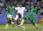 Canada's Nichelle Prince battles for the ball with Cameroon's Christine Manie, right, and Raissa Feudjio, left, during the Women's World Cup Group E soccer match between Canada and Cameroon in Montpellier, France, Monday, June 10, 2019. (AP Photo/Claude Paris)