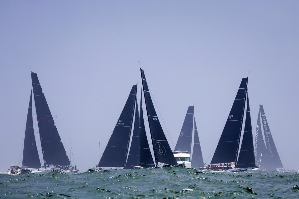 Sail boats enter open water after the start of the Sydney Hobart yacht race in Sydney, Tuesday, Dec. 26, 2023. The 630-nautical mile race has more than 100 yachts starting in the race to the island state of Tasmania. (Salty Dog/CYCA via AP)