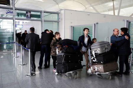 Fuad Sharef Suleman and his family push their luggages after returning from Cairo to Erbil, after U.S. President Donald Trump's decision to temporarily bar travellers from seven countries, including Iraq, at Erbil International Airport, Iraq, January 29, 2017. REUTERS/Ahmed Saad