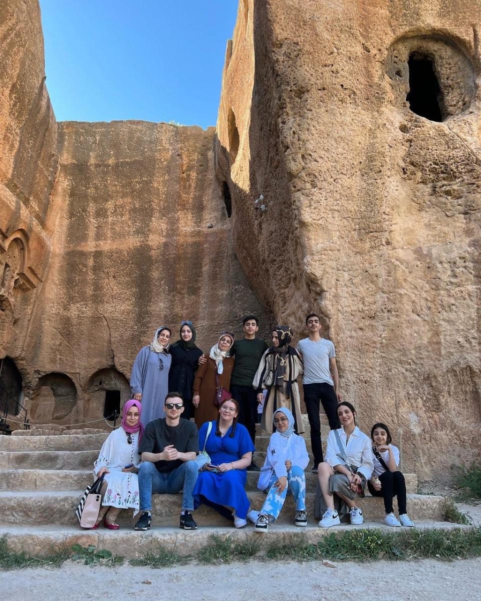 Barnstable residents Ashley Aytek, 28, (center, seated) and Umut Aytek, (left of Ashley Aytek) with their family in Diyarbakir during a trip to Turkey. Ashley Aytek has been living on the Cape all her life and Umut moved to Cape Cod in 2019.