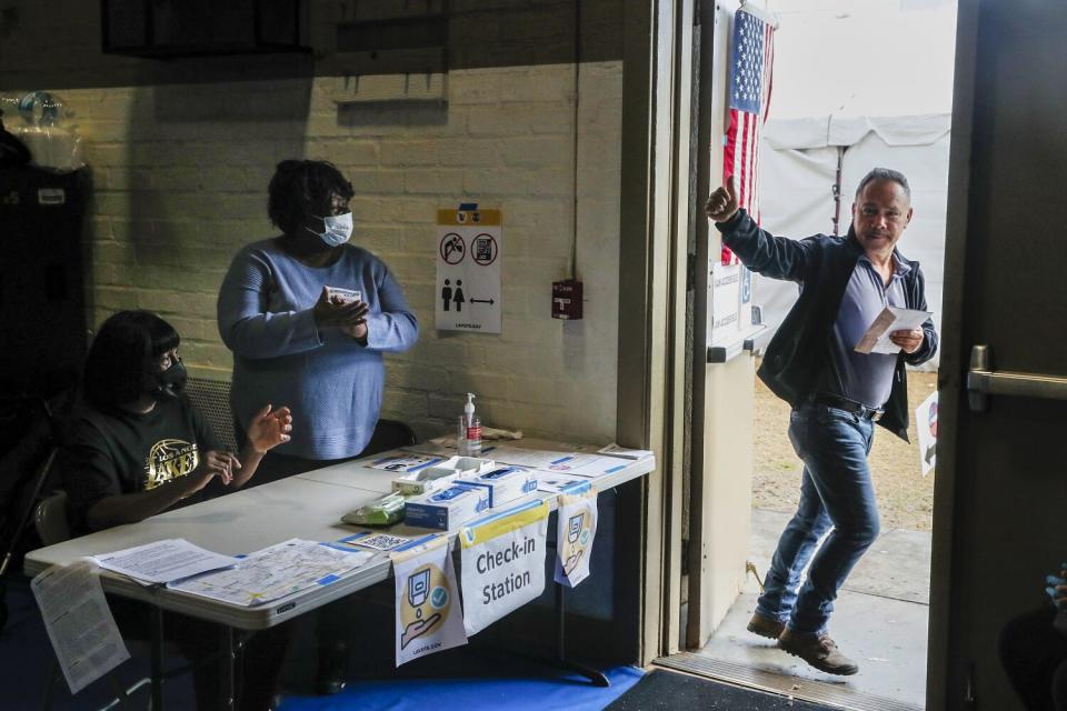 A man gives a thumbs-up as he leaves a voting center