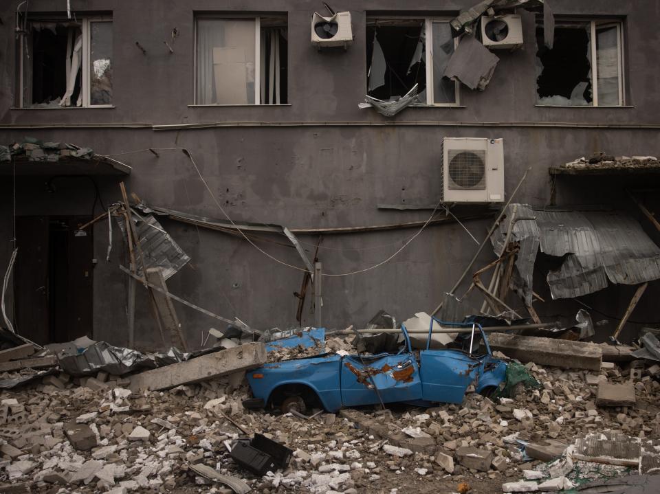 A destroyed vehicle sits at the bottom of an office block used as a HQ for Russian forces (Getty Images)