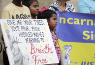 <p>Young girls take part in a vigil at San Fernando Cathedral for victims who died as a result of being transported in a tractor-trailer, Sunday, July 23, 2017, in San Antonio. Several people died after being crammed into a sweltering tractor-trailer found parked outside a Walmart in the midsummer Texas heat, authorities said Sunday in what they described as an immigrant-smuggling attempt gone wrong. (AP Photo/Eric Gay) </p>