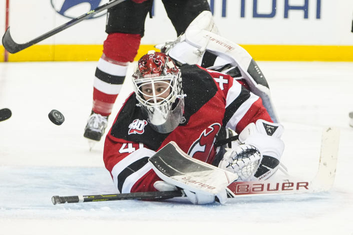 New Jersey Devils' Vitek Vanecek watches the puck after stopping a shot on goal by Pittsburgh Penguins' Ryan Poehling (during the third period of an NHL hockey game, Sunday, Jan. 22, 2023, in Newark, N.J. The Devils won 2-1 in overtime. (AP Photo/Frank Franklin II)