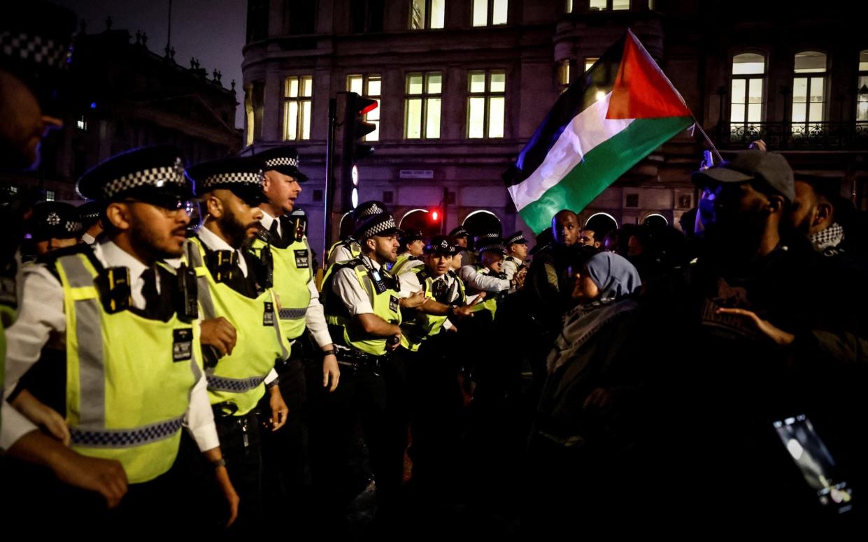 Metropolitan Police officers face Pro-Palestinian supporters during a "Hands off Rafah, End the genocide" rally in central London