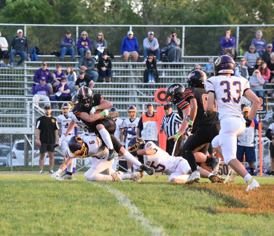 Hudson's Beckett McCaskey runs over the Onsted defense during Friday's game in Hudson.