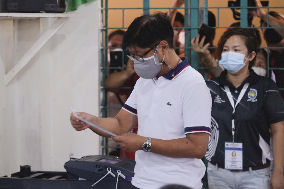 Presidential candidate Ferdinand Marcos Jr., the son of the late dictator, looks at the receipt after voting at a polling center in Batac City, Ilocos Norte, northern Philippines on Monday, May 9, 2022. Filipinos were voting for a new president Monday, with the son of an ousted dictator and a champion of reforms and human rights as top contenders in a tenuous moment in a deeply divided Asian democracy. (AP Photo)